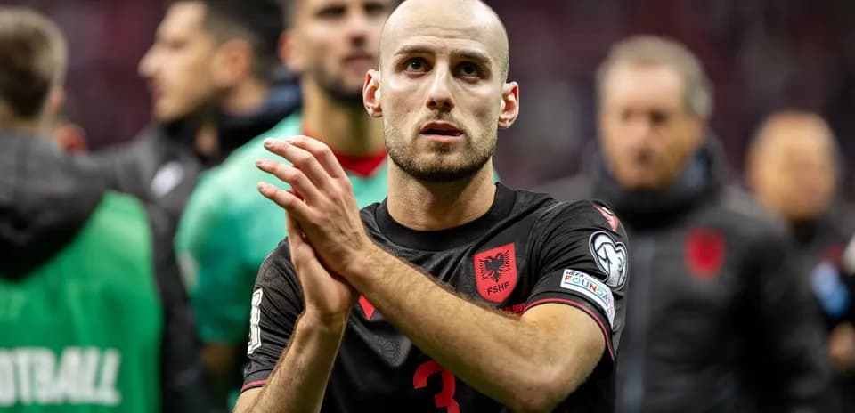 Albanian player applauding fans after match