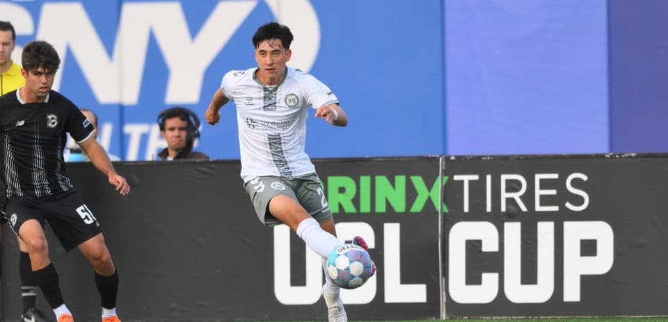 Player dribbling ball during USL Cup match