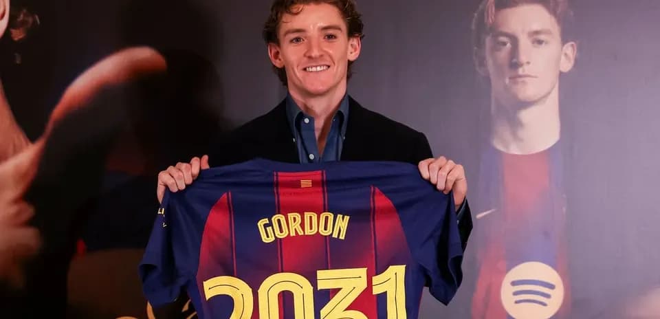 Player holding FC Barcelona jersey with name and number