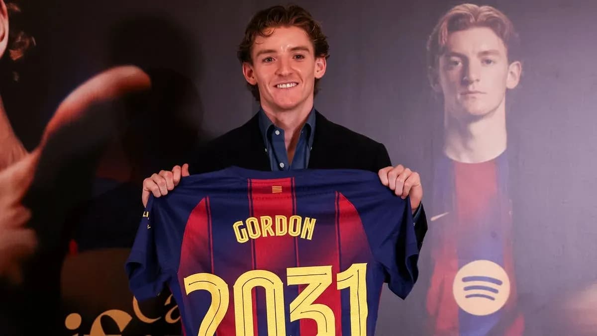 Player holding FC Barcelona jersey with name and number