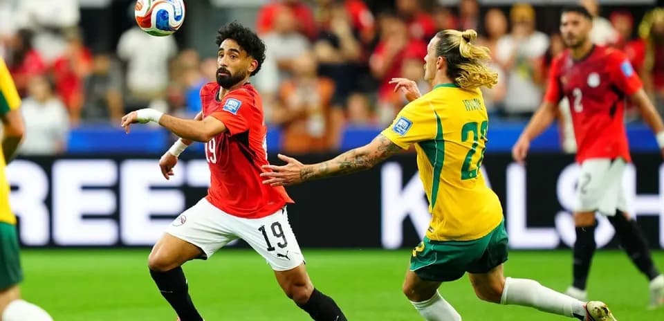 Egyptian player controlling ball against Australian opponent