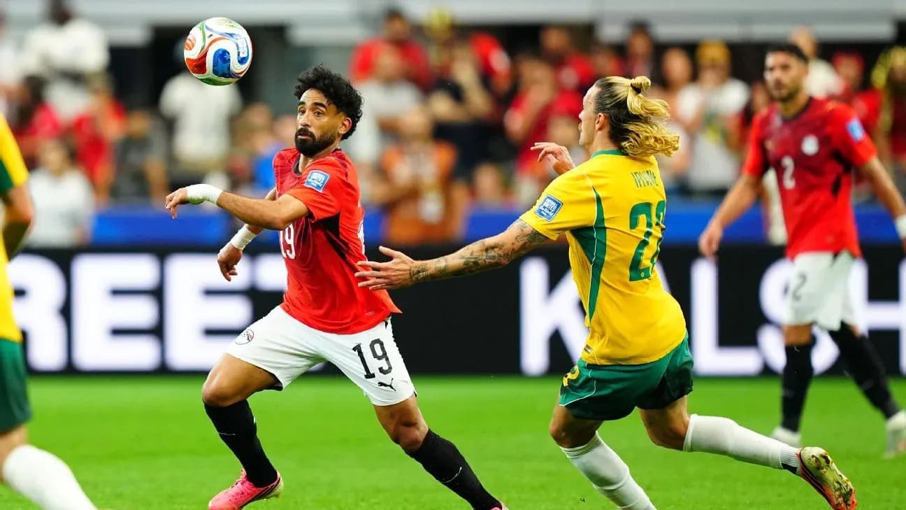 Egyptian player controlling ball against Australian opponent