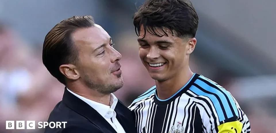 Coach and player celebrating after a match