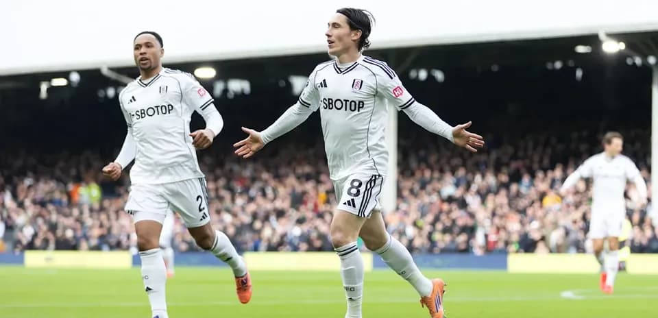Fulham players celebrating a goal on the field
