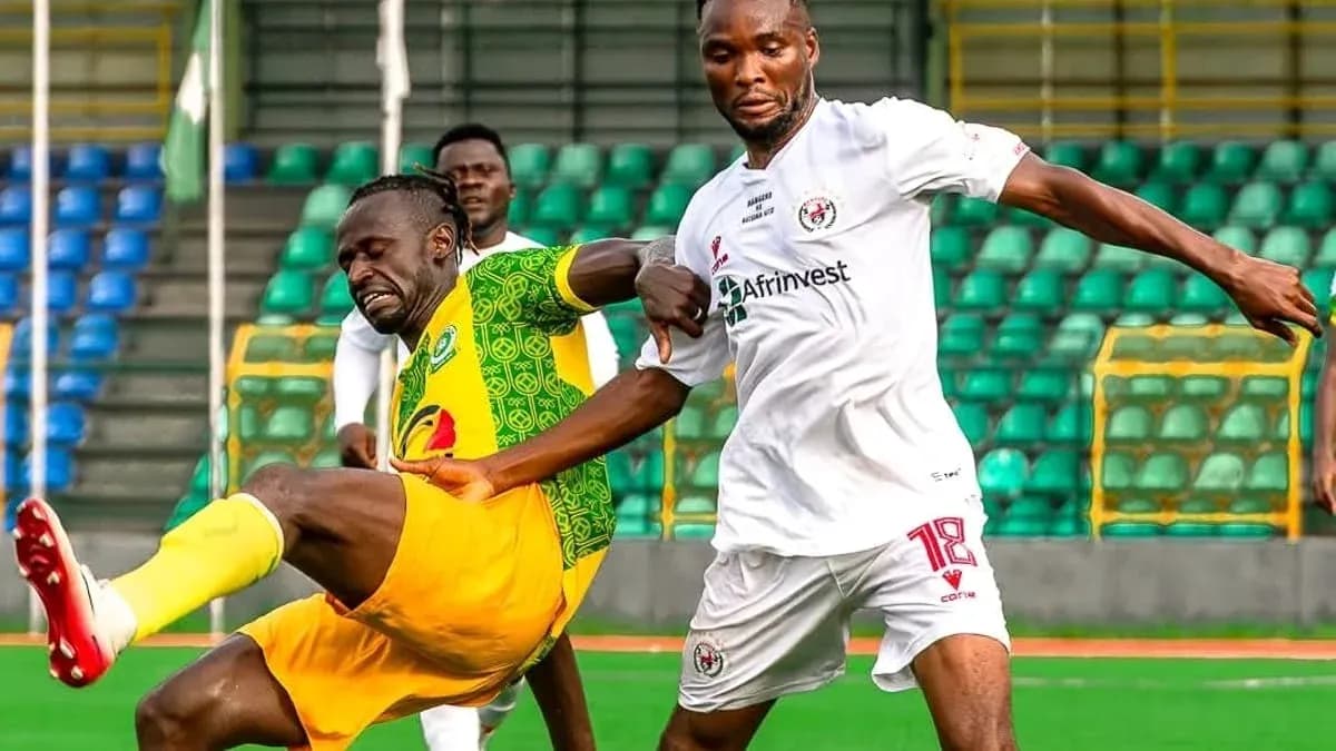 Katsina United player challenged by Rivers United player