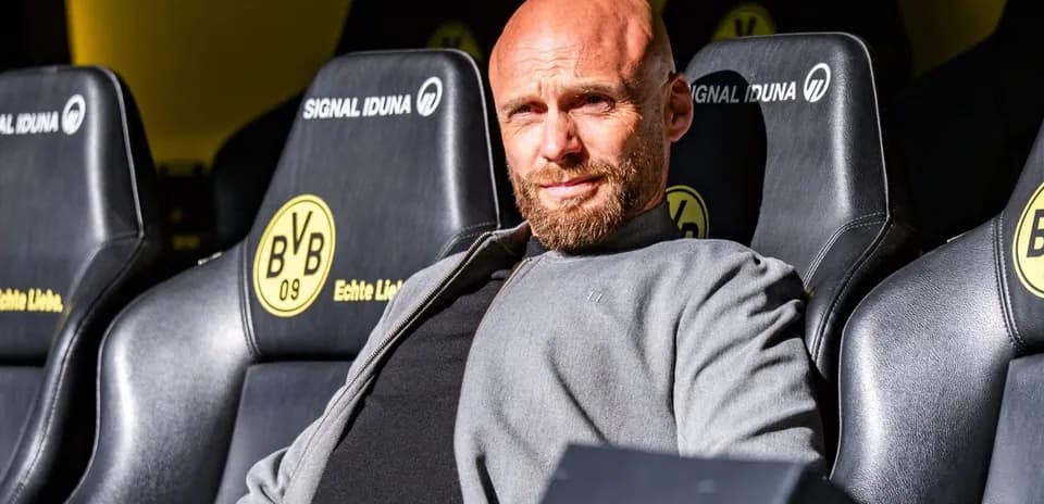 Coach sitting on team bench at stadium