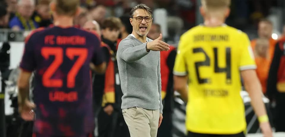 Coach giving instructions during a football match