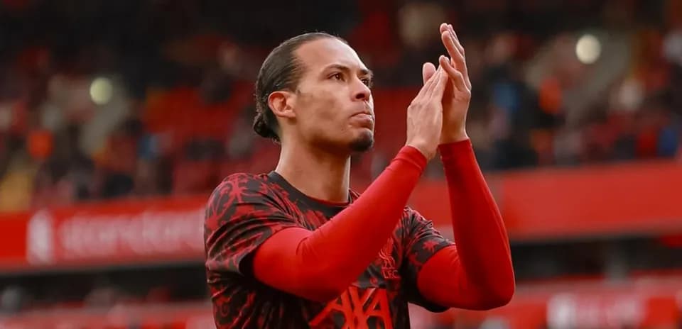 Player applauding fans in Liverpool kit at stadium