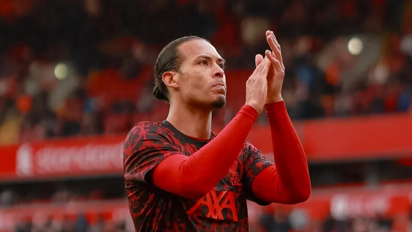 Player applauding fans in Liverpool kit at stadium