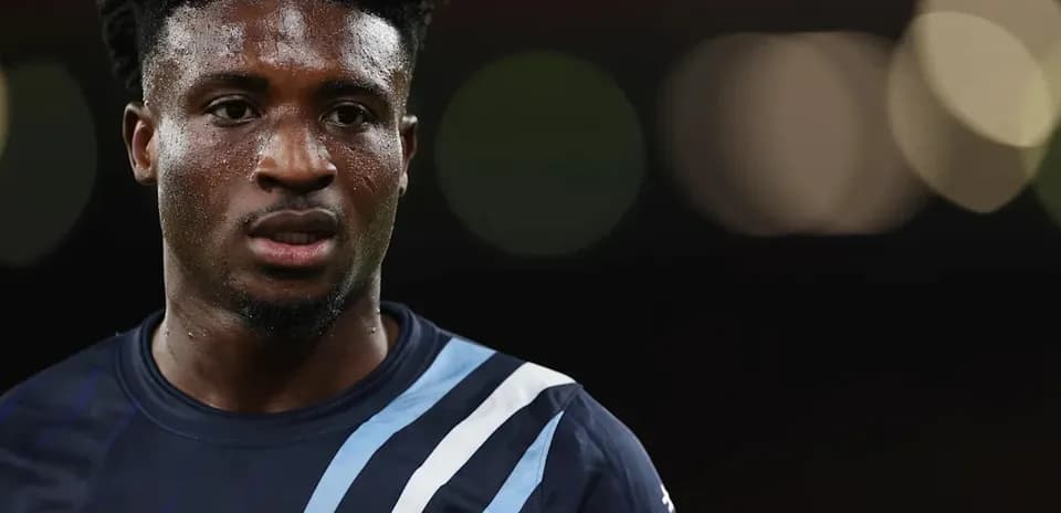 Player wearing dark jersey with blue stripes close-up