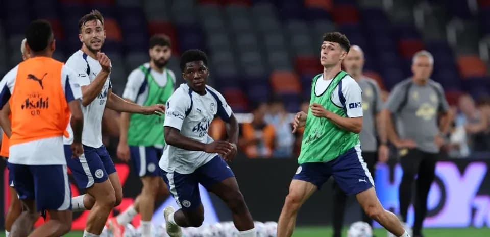 Players training with a soccer ball on pitch