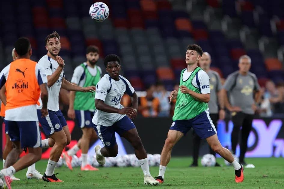 Players training with a soccer ball on pitch