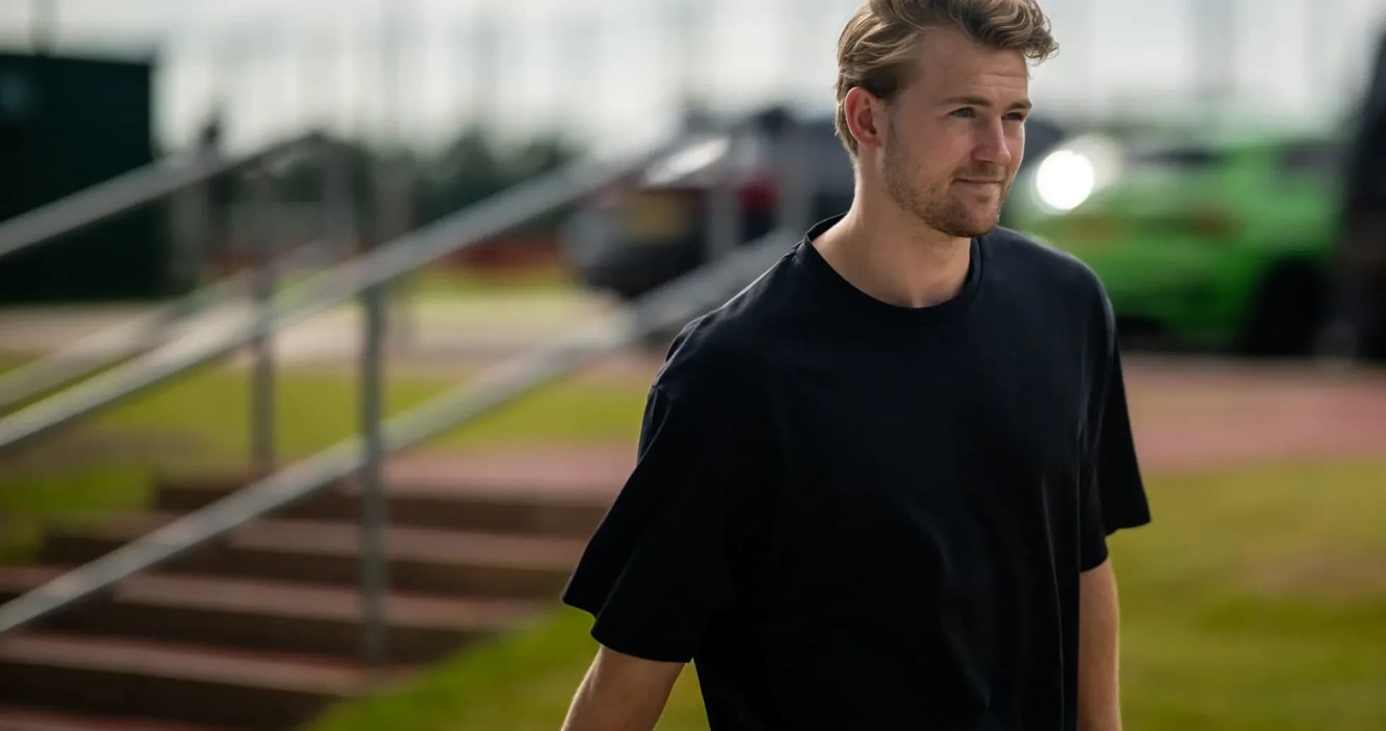 Player walking on training ground towards facility