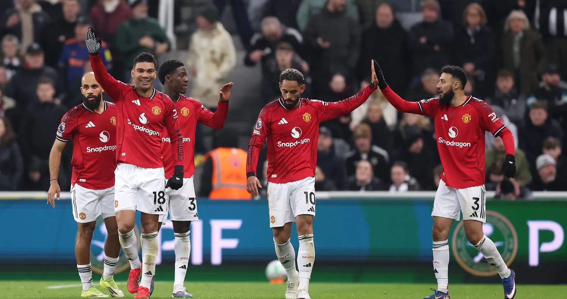 Manchester United players celebrating a goal together