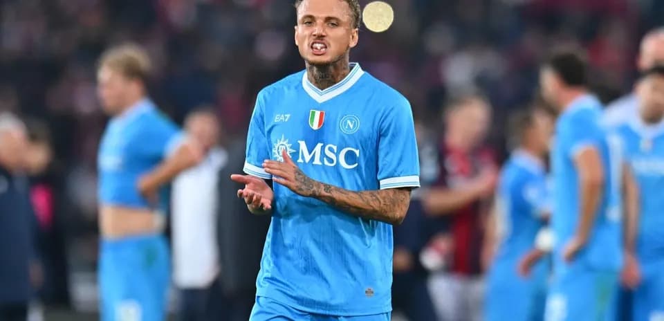 Player in blue Napoli kit gestures on the field