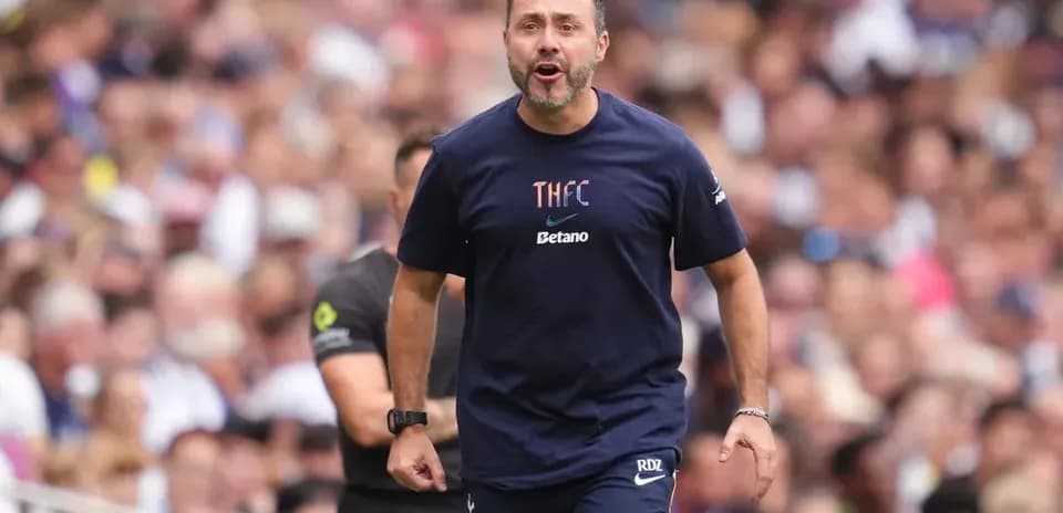Coach directing players during a match on the sidelines