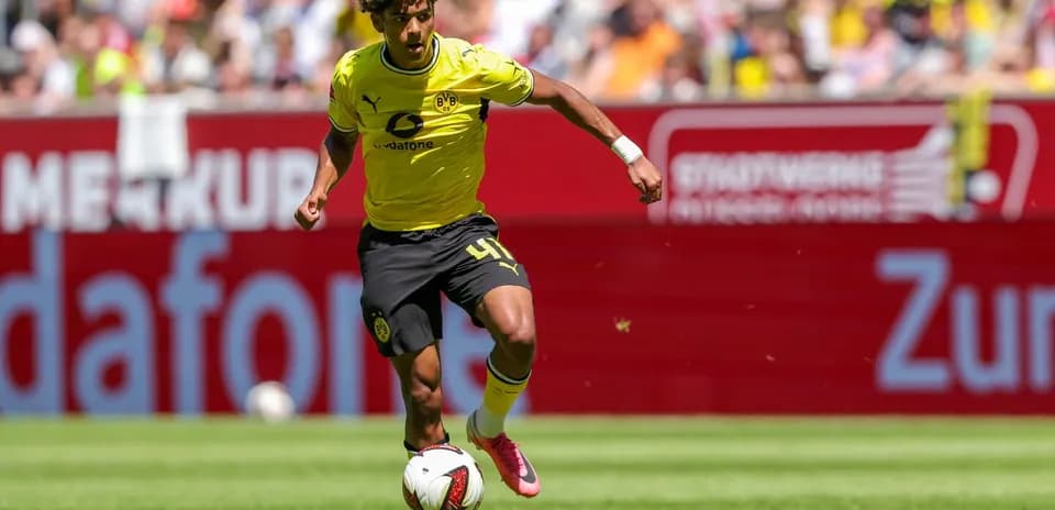 Player in yellow jersey dribbling the ball on field