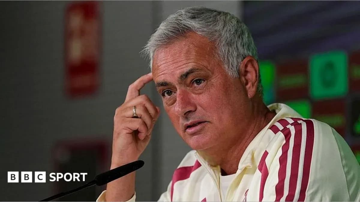 Manager speaking at press conference with microphone
