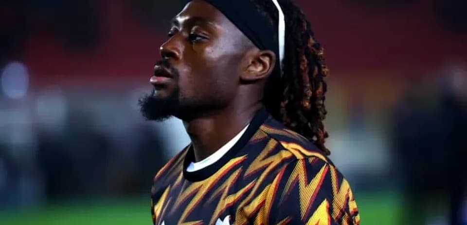 Player in colorful jersey walking on the pitch