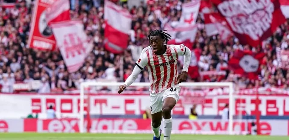 Player dribbling the ball in front of cheering fans