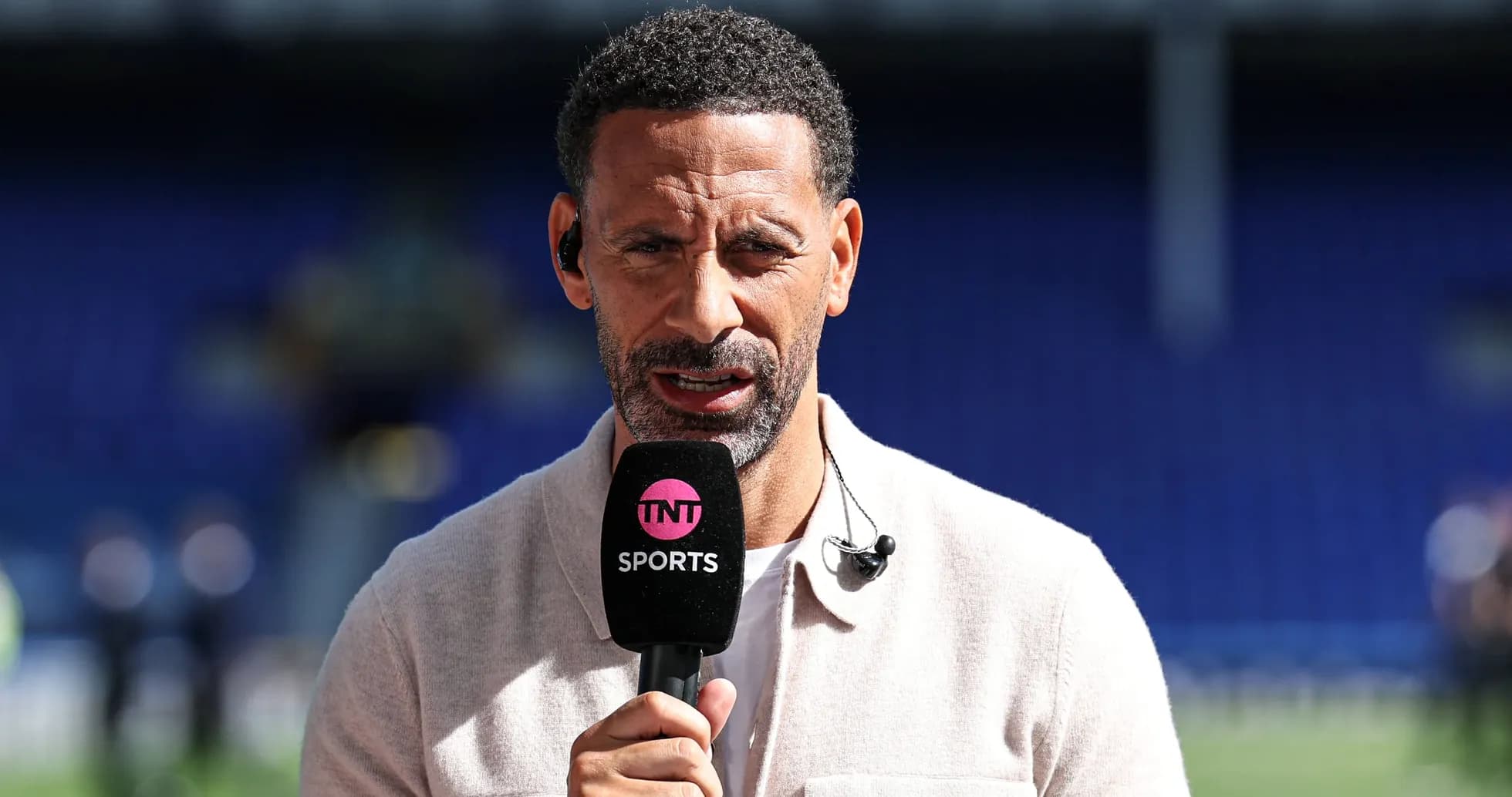 Presenter speaking into microphone on sports set