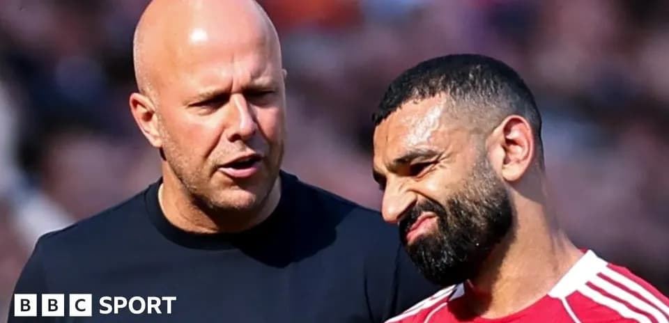 Two men talking on the sidelines of a match