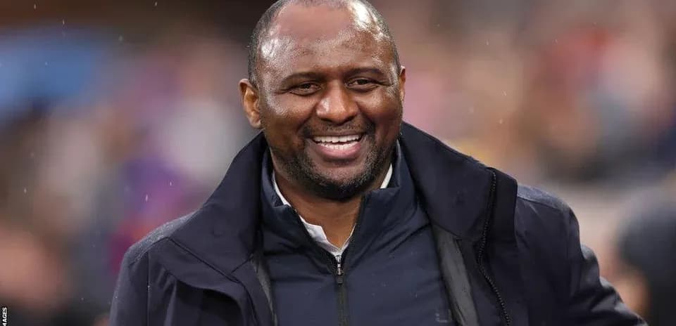 Smiling coach during a match at the stadium