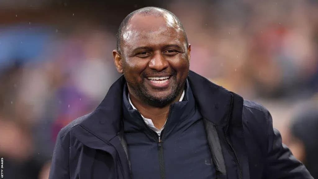 Smiling coach during a match at the stadium