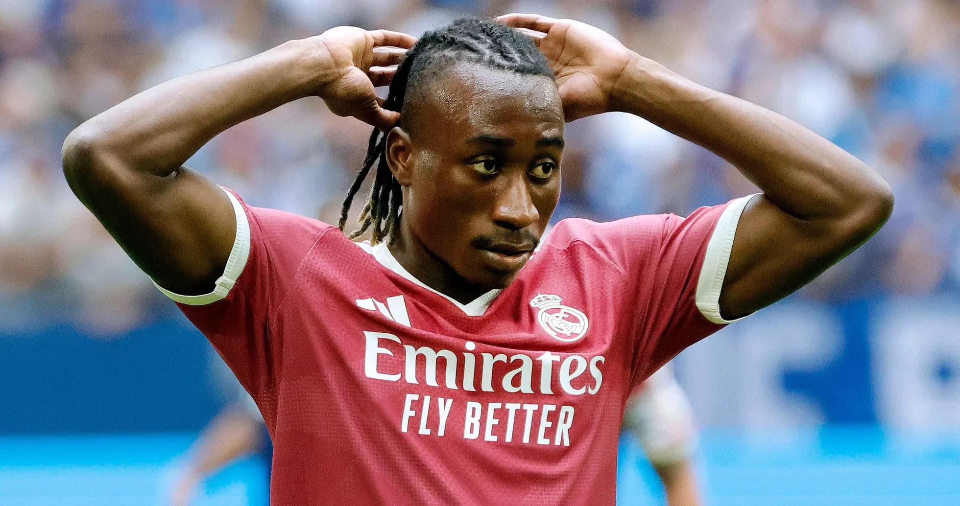 Player in pink jersey adjusting his hair during match