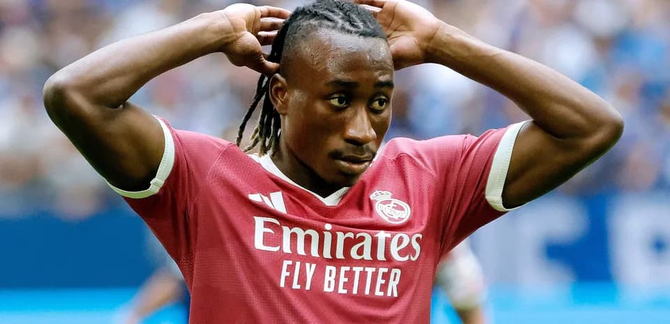 Player in pink jersey adjusting his hair during match