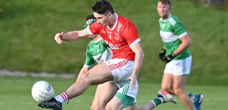 Player kicking ball during Gaelic football match