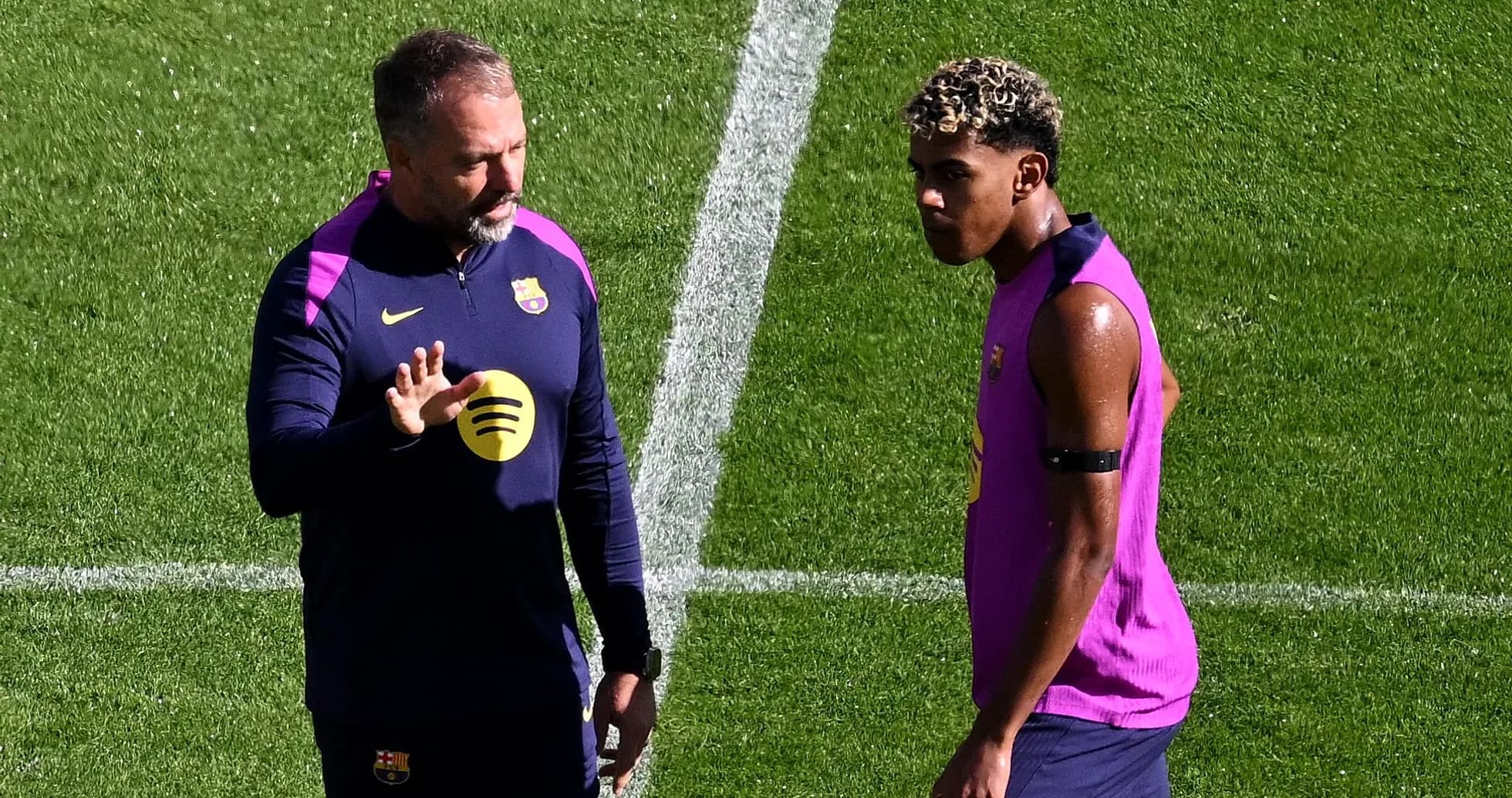 Coach instructing player during Barcelona training session