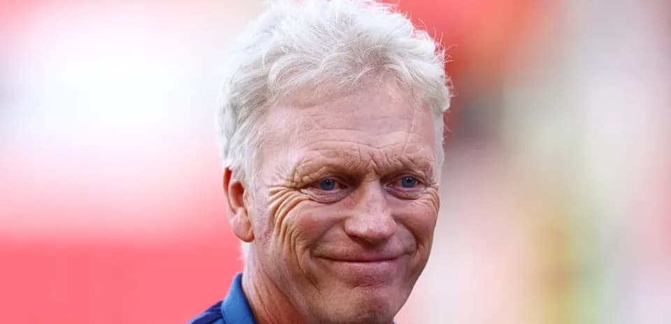 Manager smiling during pre-match warm-up