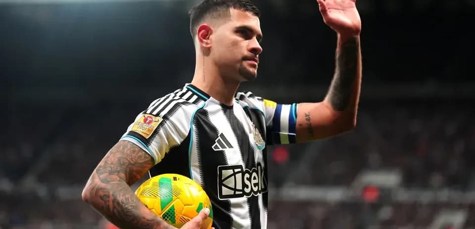 Player waving while holding a soccer ball