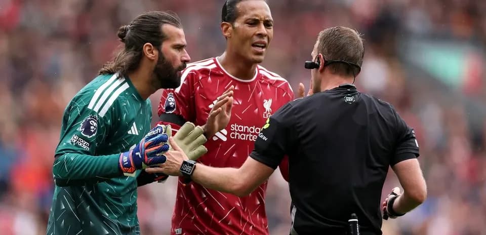 Alisson and Van Dijk discussing with the referee