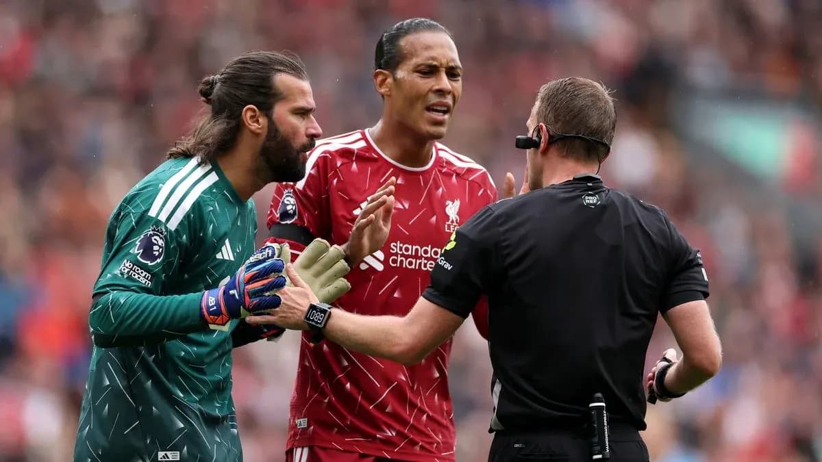 Alisson and Van Dijk discussing with the referee