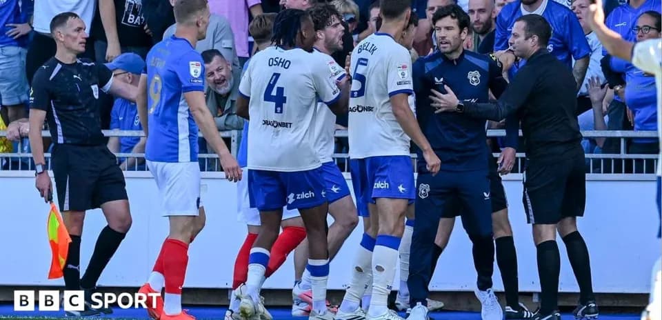 Players and officials discussing a contentious call during match
