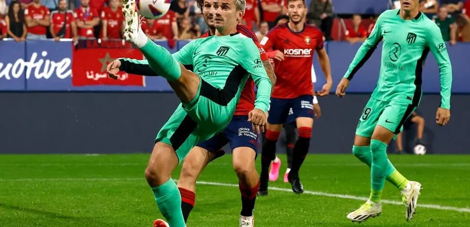 Atletico Madrid player kicking the ball during match