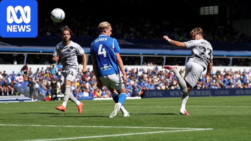 Player striking ball during football match action