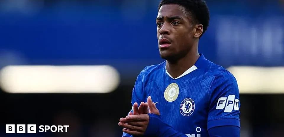 Player in blue Chelsea kit applauding fans