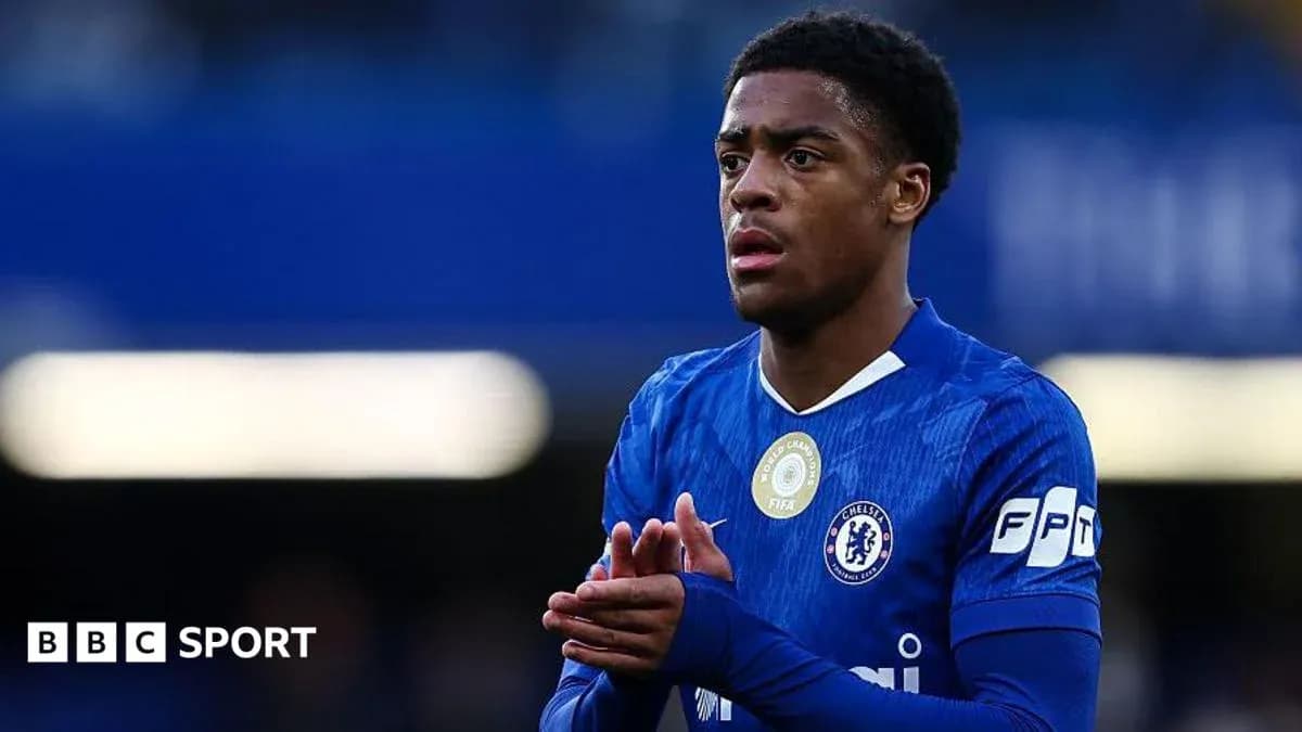Player in blue Chelsea kit applauding fans