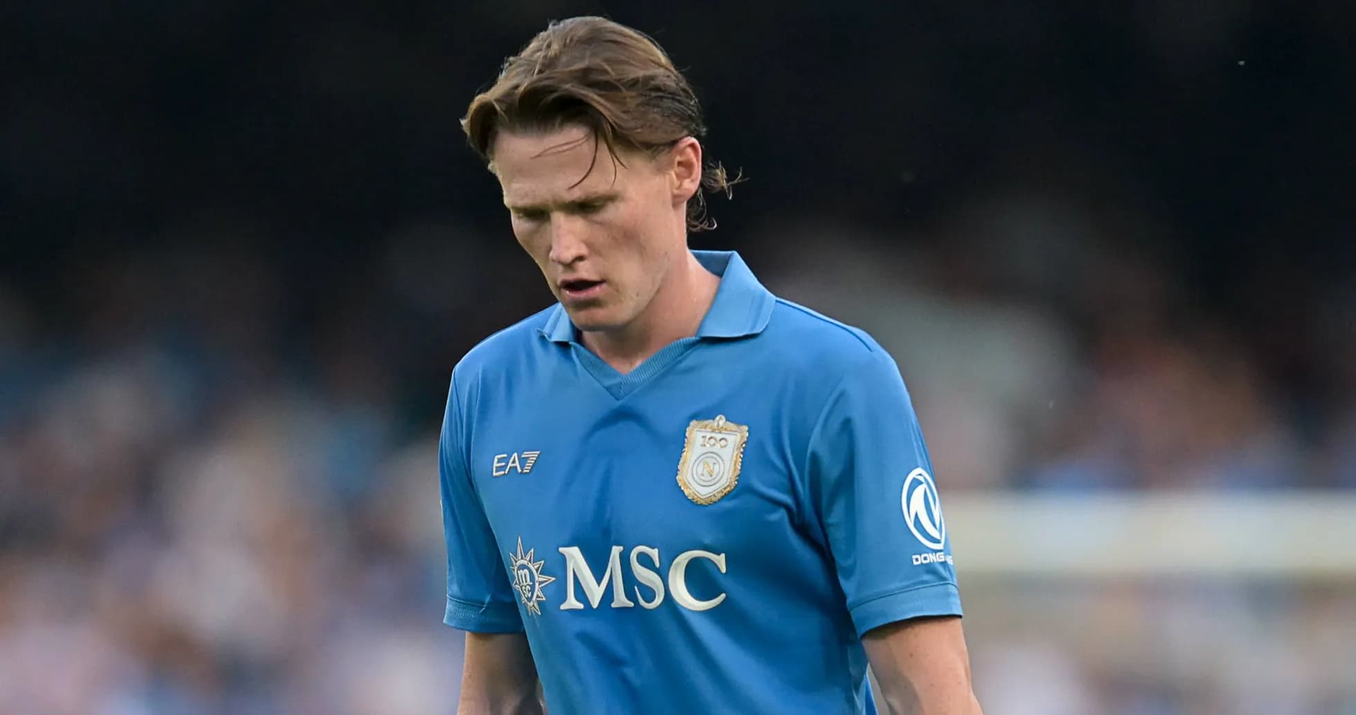 Player in blue kit walking during a match