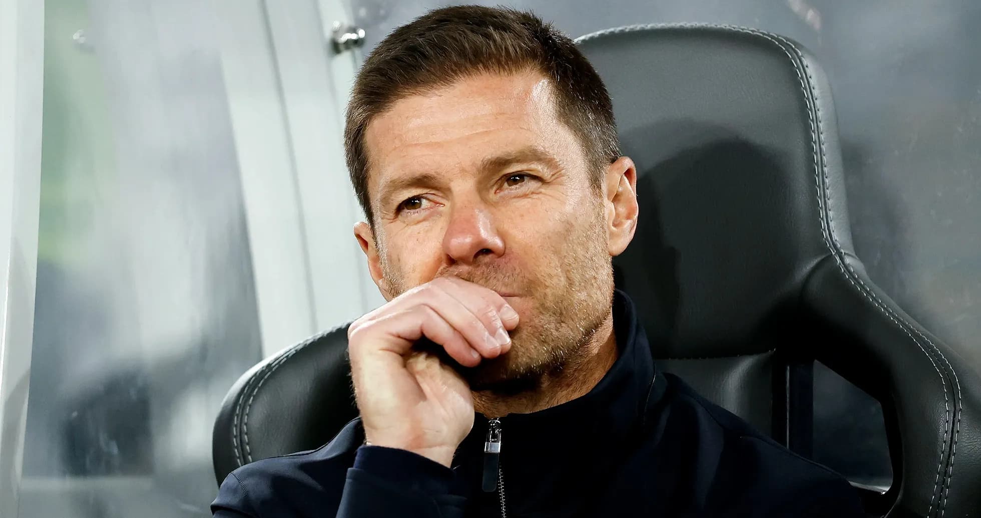 Coach sitting on bench during match observation