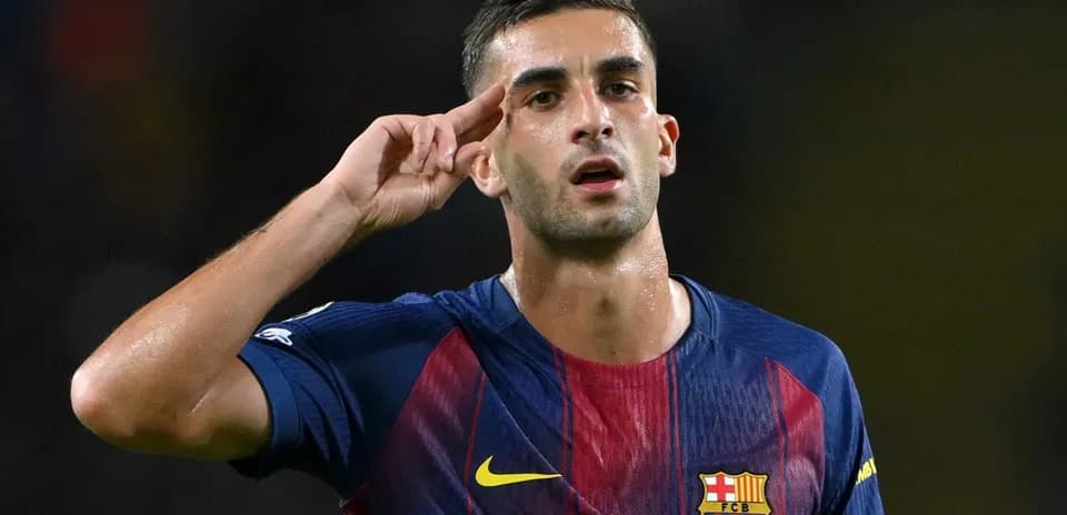 Player celebrating with a salute gesture on pitch
