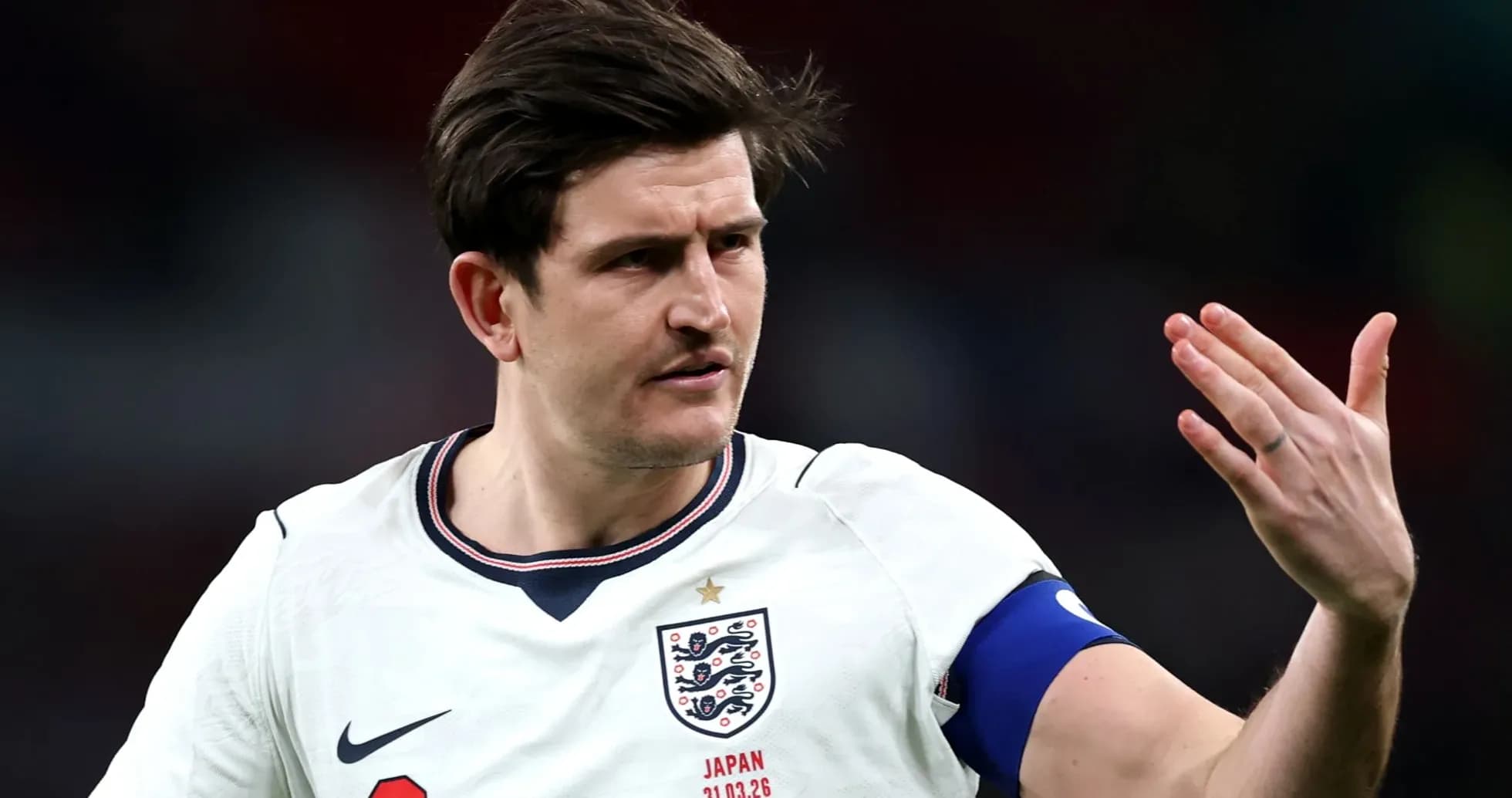 Player gesturing during a football match for England