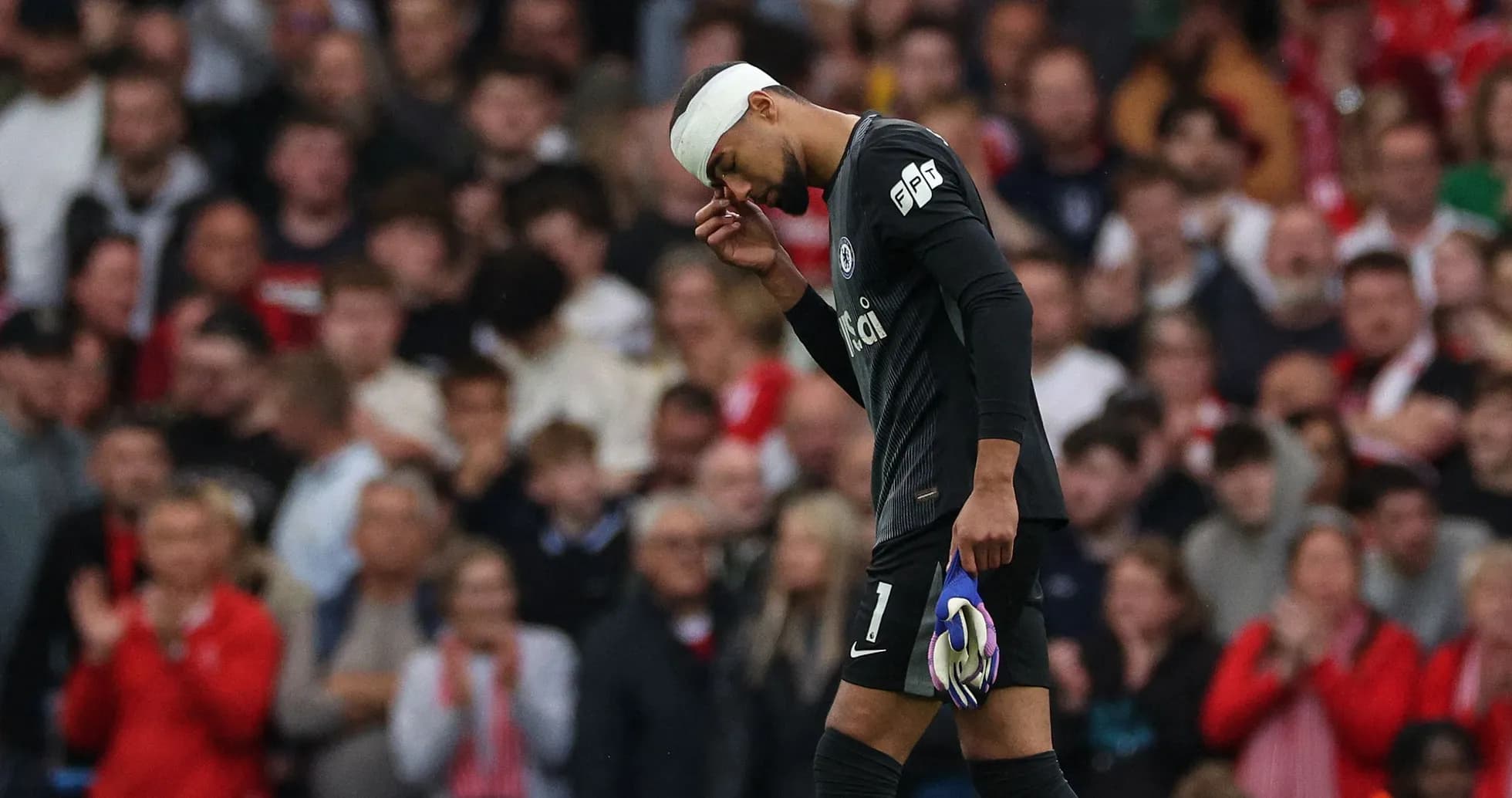 Goalkeeper with bandaged head walking off field