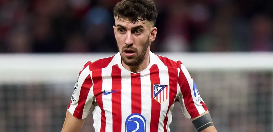 Atletico Madrid player in red and white striped jersey