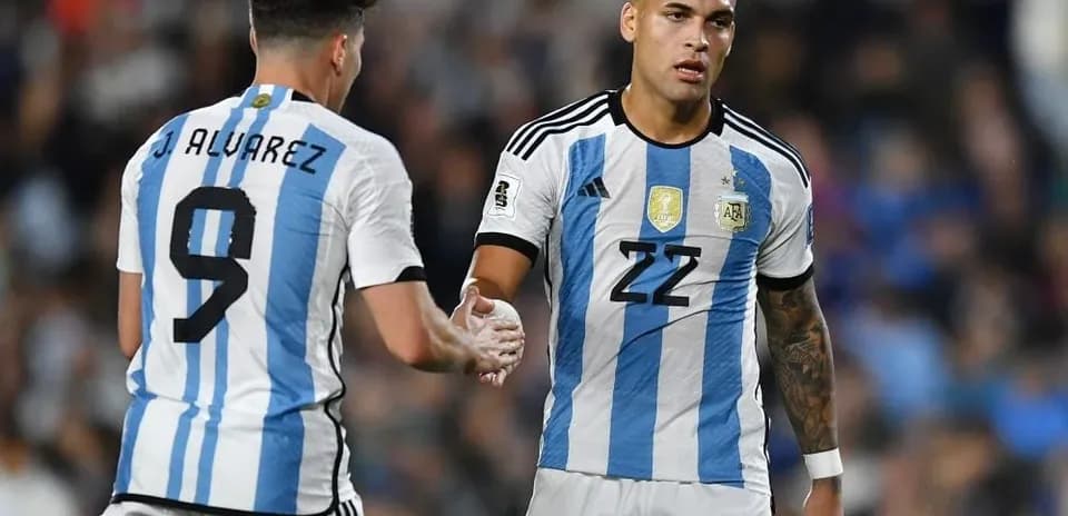 Two Argentine players shaking hands on the field