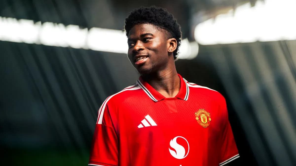 Player wearing Manchester United jersey, smiling