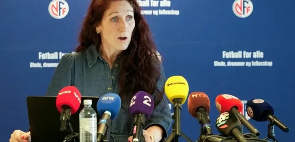 Speaker at press conference with multiple microphones